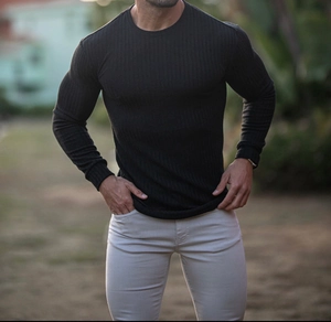 Close-up of men's slim fit black ribbed long sleeve tee showing textured knit fabric