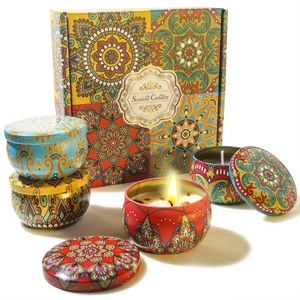 Macro shot of colorful mandala tin scented candles and elegant gift box packaging