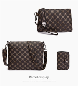 Detailed view of 3-piece bag set with vintage clover print and golden hardware details