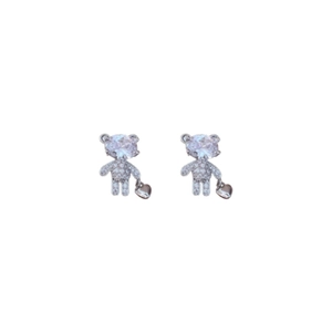 Asymmetric silver bear and heart lock earrings with zircon stones on white background