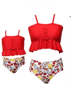 Detail of red bikini top with ruffled hem and lemon floral high-waisted bottoms