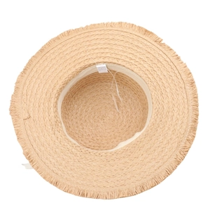 Detail view of straw sun hat featuring a fringed brim and interior size adjustment strap