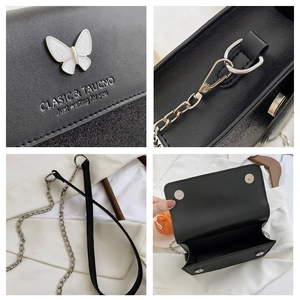 Classic black crossbody bag with white butterfly hardware and silver chain strap details