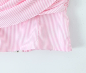 Macro detail of pink striped fabric texture and precise stitching on clothing hem