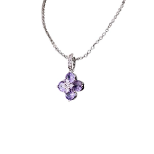 Elegant silver necklace with clover flower pendant featuring purple zircons and white crystals