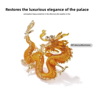 Macro detail of golden dragon brooch with red gem eyes and 360-degree mirror polishing