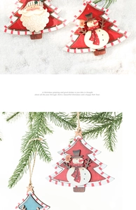 Detail of wooden Christmas tree ornament with painted Santa Claus and snowman on pine branches