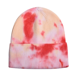 Detailed view of tie-dye knit beanie texture in vibrant pink and orange gradient