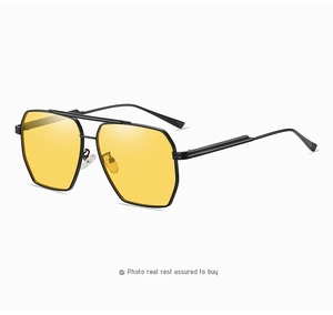Detail view of yellow lenses on black metal double-bridge aviator driving glasses