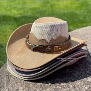 Detail of western straw cowboy hat featuring breathable mesh crown and bull head ornament