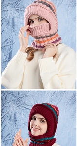 Detail of chunky knit winter hood with colorful jacquard stripes and faux fur pompom