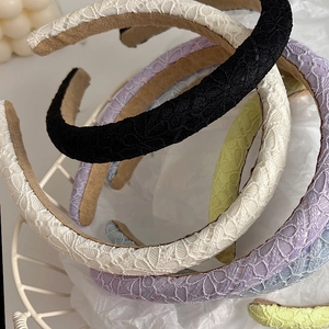 Detailed macro view of lace crochet headbands showing intricate floral textures and sponge core