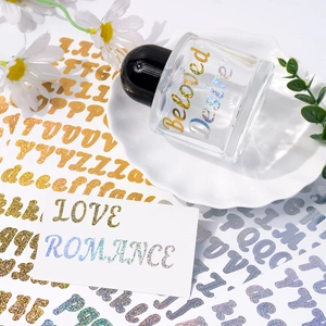 Close-up of gold and silver glitter alphabet stickers on glass jars for decoration