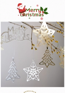 Close-up of star and tree-shaped metal Christmas ornaments on natural branches