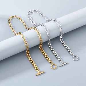 Detailed macro of gold and silver double-strand chain necklace with stylish OT toggle clasp