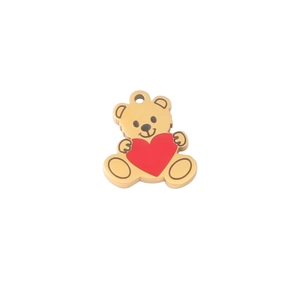 Close-up of a golden teddy bear pendant with a red heart for DIY jewelry making