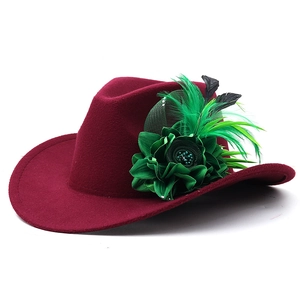 Detail of burgundy wool fedora with emerald green silk flower and feather accents