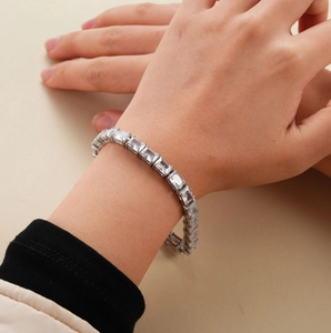 Close-up of sparkling square-cut zircon stones set in a silver tennis bracelet