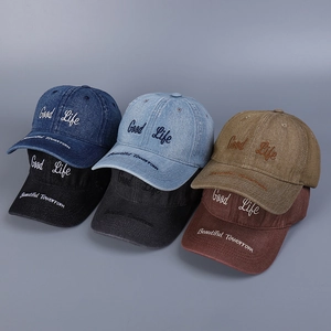 Detail of embroidered Good Life lettering and washed denim texture on baseball caps