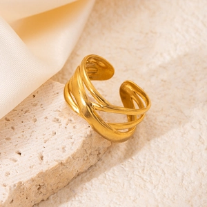 Macro view of textured 18K gold-plated stainless steel multi-layer open ring on stone