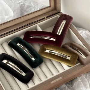 Rectangle velvet hair clips in six colors displayed in a wooden jewelry box for styling