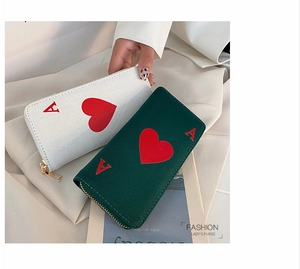 Detail of canvas long wallets featuring Ace of Hearts design and gold metal zippers