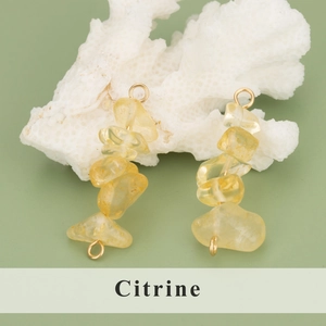 Handmade natural citrine crystal charm with gold metal clasp on white coral base