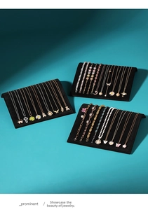 Macro shot of assorted gold and silver necklaces displayed on S-shaped velvet stands