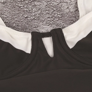 Detail view of one-piece swimsuit featuring black and white contrast with V-mesh insert