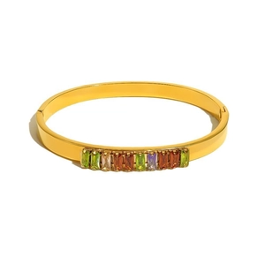 Close-up of golden metal bracelet set with multi-colored rectangular gemstones on white back