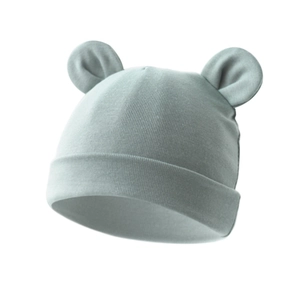 Detail of infant knit hat in sage green with soft texture and cute bear ear design