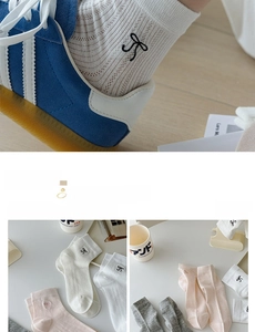 Detail of ribbed cotton socks with bow embroidery in white, pink and grey colors