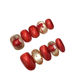 Faux ongles de Noël faits main en rouge et or pailleté avec nœuds 3D décoratifs