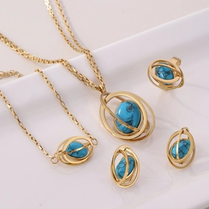 Detailed set of gold planet jewelry featuring blue turquoise stones on white tray