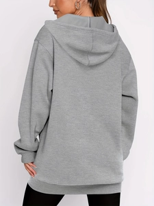 Rear view of grey oversized hooded sweatshirt showing loose fit and ribbed cuffs