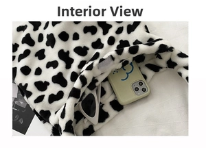 Detailed interior of plush cow print tote bag showing large capacity and velcro closure