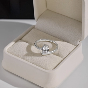 S925 sterling silver ring with oval zircon center stone in a beige velvet jewelry box
