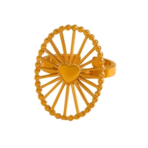 Detail of golden stainless steel adjustable ring with radial texture and heart center