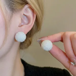 Minimalist silver round frosted stud earrings with a textured starlight metallic finish