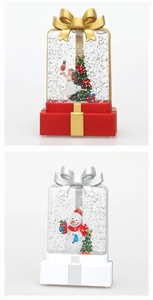 Close-up of gift box water lanterns with Christmas tree, snowman and glitter detail