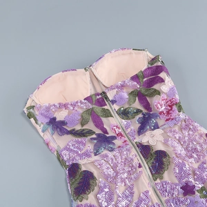 Detail of floral embroidery and sequins on the purple mesh strapless evening gown