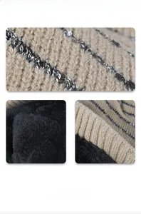 Detail view of striped knit exterior and thick black fleece lining for winter warmth