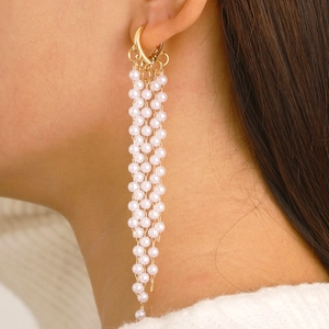 Elegant gold drop earrings with long pearl tassels and minimalist heart clasp design