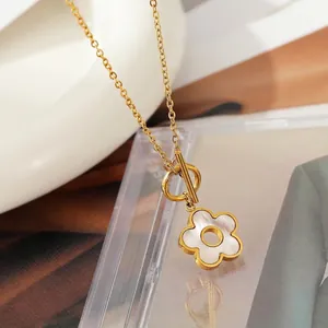 Gold plated titanium necklace with white flower pendant and decorative OT toggle clasp