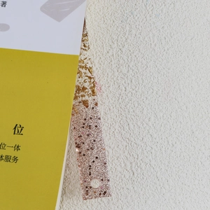 Detail of DIY resin bookmark mold featuring gold foil flakes and a pre-drilled hanging hole