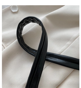 Close-up of thick black leather shoulder strap showing soft texture and premium stitching