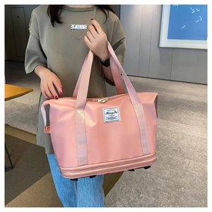 Pink large capacity travel bag held by model featuring expandable bottom layer nylon