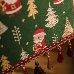 Green Christmas table runner with Santa jacquard pattern and decorative tassels