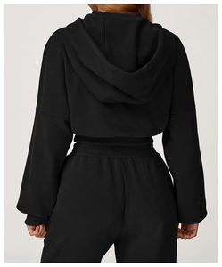Rear view of black hooded tracksuit featuring premium ribbed cuffs and matte fabric texture