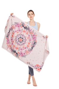 Detail view of pink microfiber beach towel with mandala flower pattern and soft texture